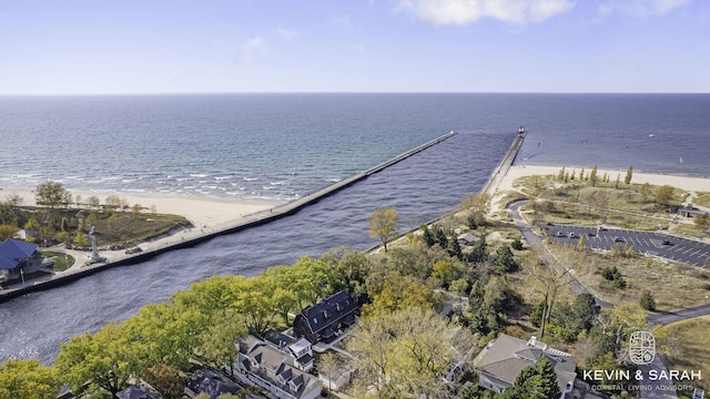 bird's eye view with a water view and a beach view