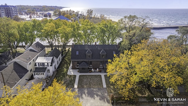 birds eye view of property with a water view and a beach view