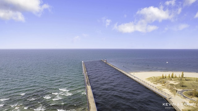 dock area featuring a water view and a view of the beach