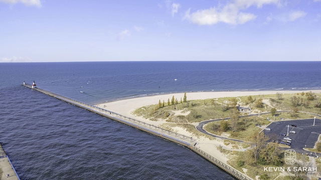 drone / aerial view with a water view and a view of the beach