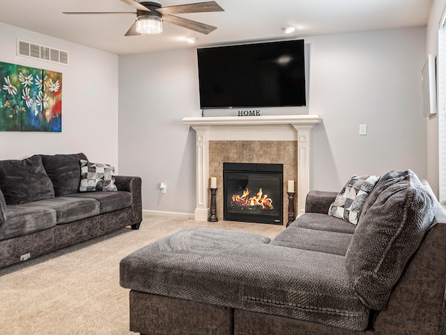 carpeted living room featuring ceiling fan