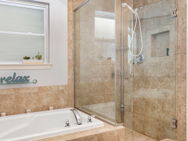 bathroom with shower with separate bathtub