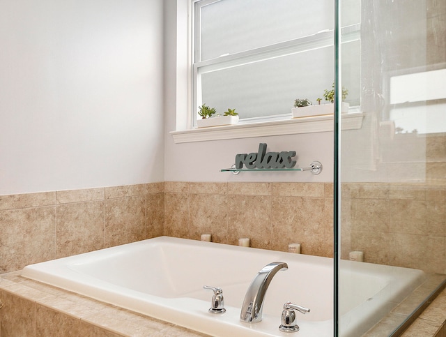 bathroom featuring tiled bath