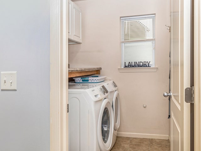 laundry area with cabinets, washer and clothes dryer, and light tile patterned flooring