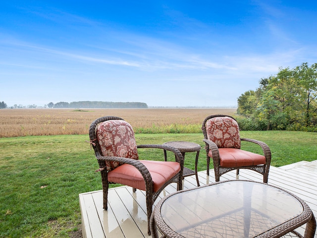 wooden deck with a rural view and a yard