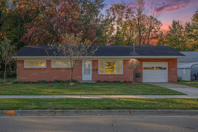 single story home with a lawn and a garage