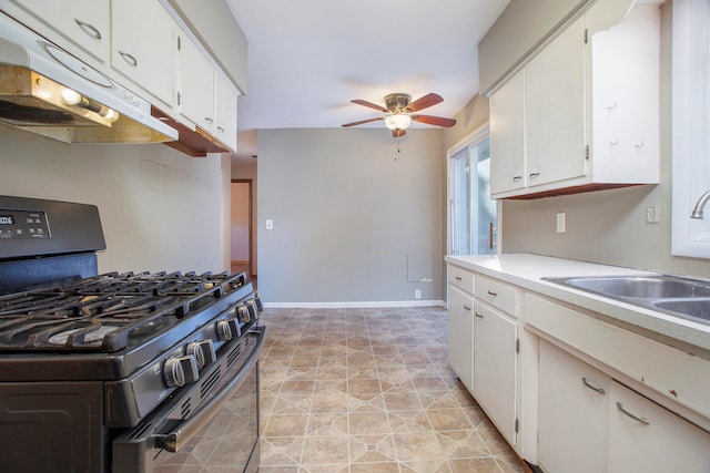 kitchen with white cabinets, ceiling fan, black gas stove, and sink