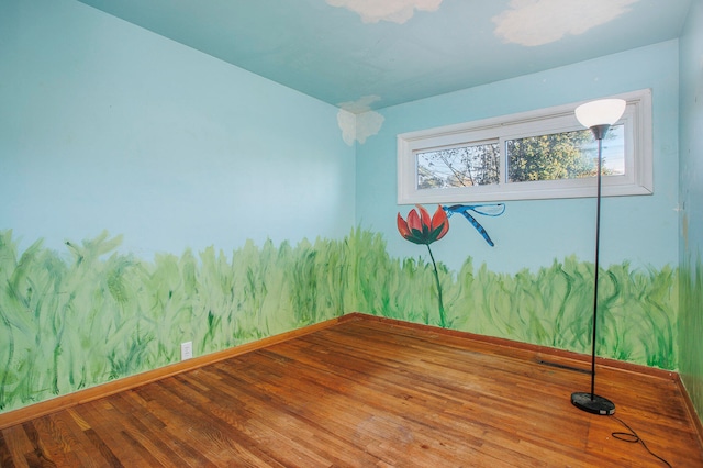 spare room with wood-type flooring