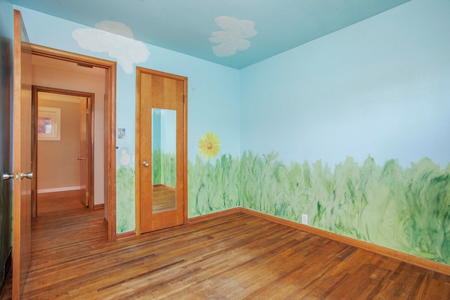 unfurnished room featuring wood-type flooring