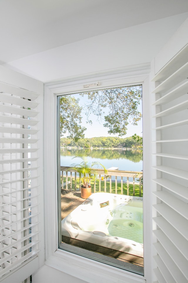 entryway with a water view and a healthy amount of sunlight