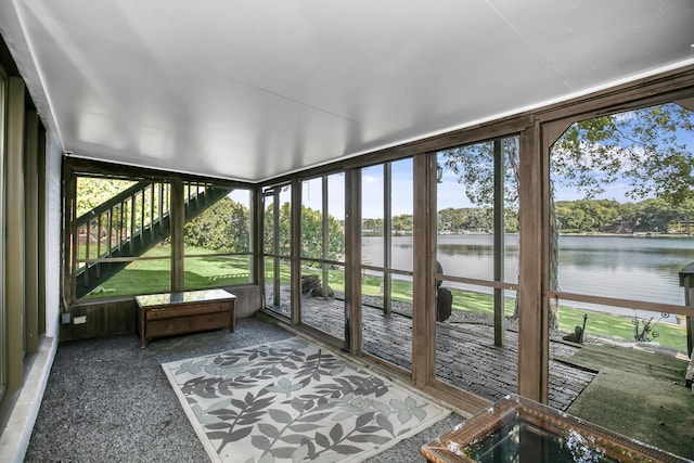 unfurnished sunroom featuring a water view