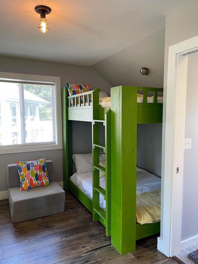 unfurnished bedroom with lofted ceiling and dark hardwood / wood-style flooring