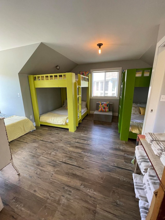 unfurnished bedroom featuring lofted ceiling and dark hardwood / wood-style flooring