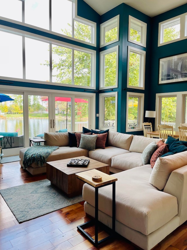 sunroom with a wealth of natural light and a water view