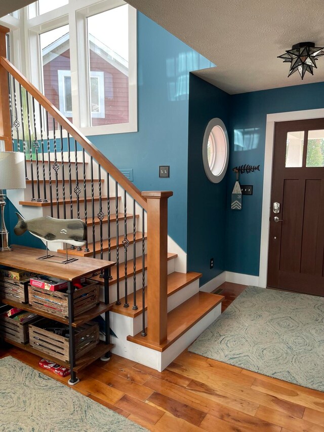 entrance foyer featuring a textured ceiling and hardwood / wood-style flooring