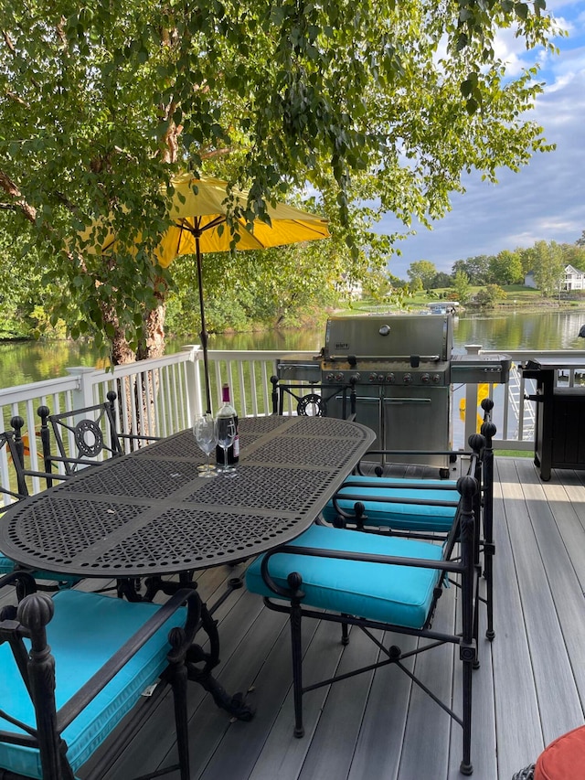 deck with a water view and a grill