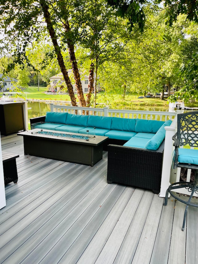 wooden terrace featuring a water view, a hot tub, and an outdoor hangout area