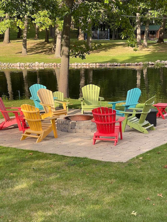 view of patio / terrace featuring a water view and an outdoor fire pit