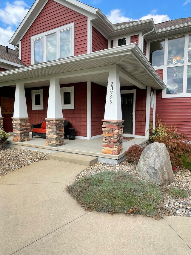 view of exterior entry with a porch