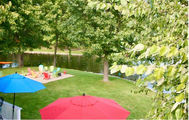 view of yard featuring a patio and a water view