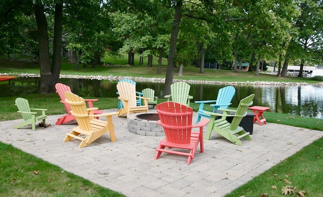 view of patio with a water view and a fire pit