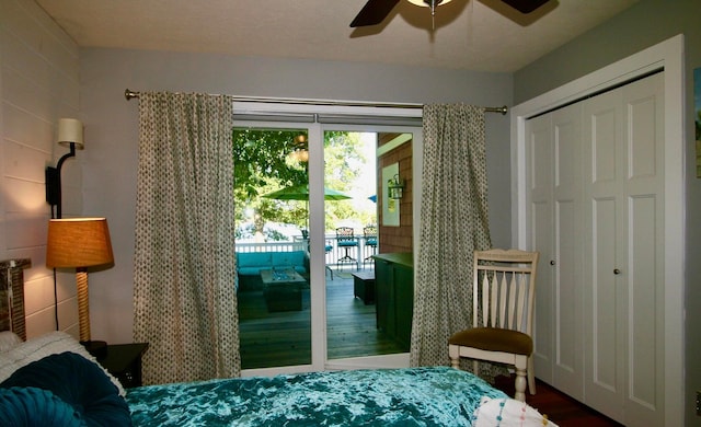 bedroom with hardwood / wood-style flooring, access to outside, ceiling fan, and a closet