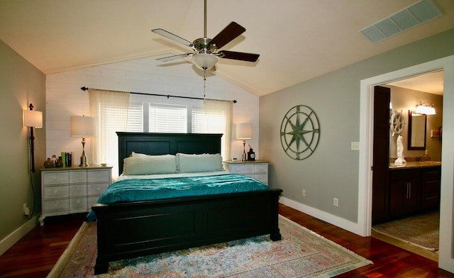 bedroom with ceiling fan, lofted ceiling, ensuite bath, and dark hardwood / wood-style flooring