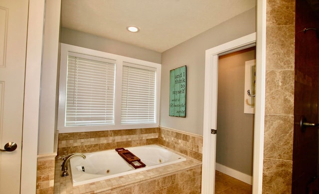 bathroom featuring tiled bath