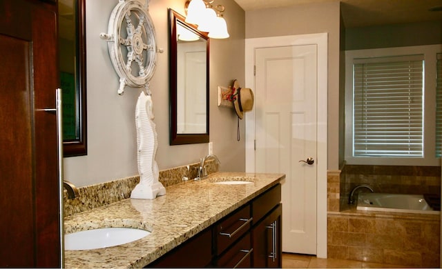 bathroom with vanity, tiled bath, and tile patterned flooring