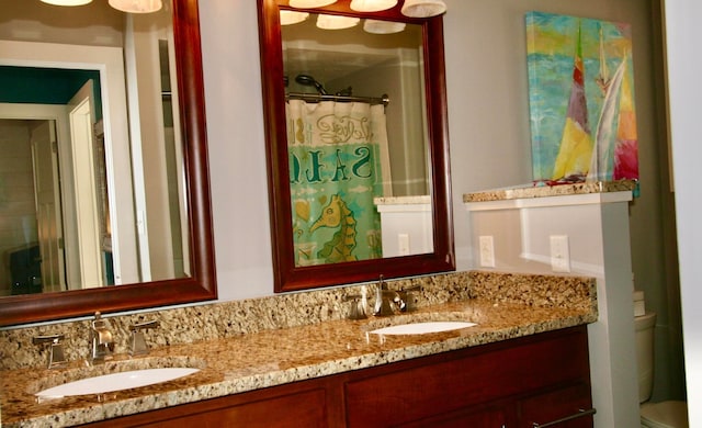 bathroom featuring vanity, toilet, and a shower with shower curtain