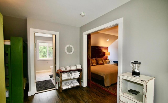 bedroom with dark hardwood / wood-style floors and vaulted ceiling