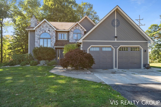 front facade featuring a front yard and a garage