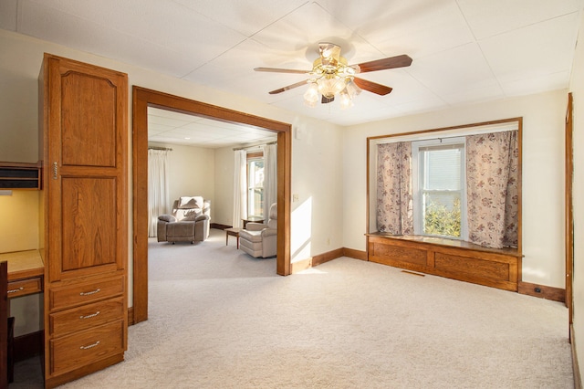 interior space featuring ceiling fan and light carpet