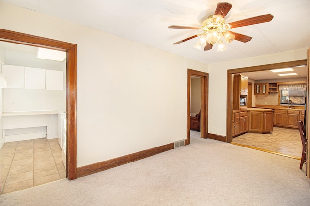 interior space with sink and ceiling fan