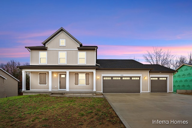 view of front of house featuring a porch and a garage