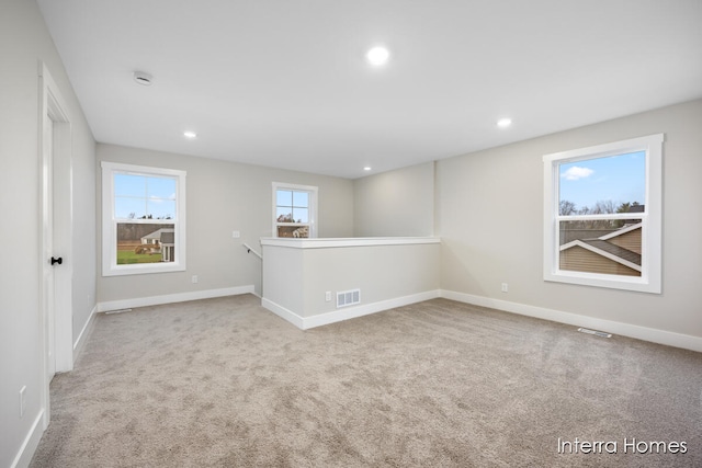 unfurnished room with light carpet