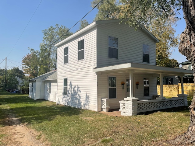 view of front of house with a porch and a front yard