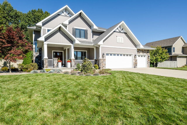 craftsman-style home with a garage, a porch, and a front lawn