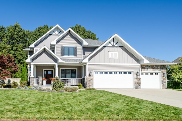 craftsman-style home featuring a porch, a front yard, and a garage