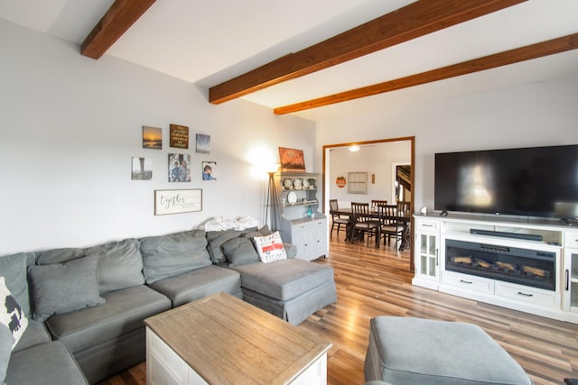 living room with beam ceiling and light hardwood / wood-style floors