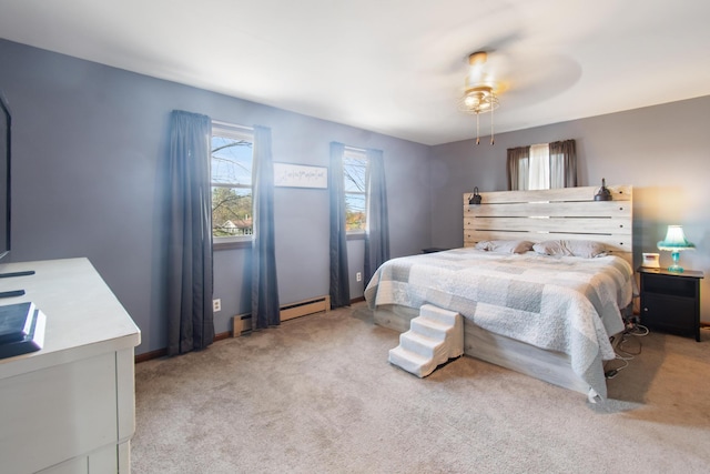 bedroom featuring ceiling fan, light carpet, and a baseboard heating unit