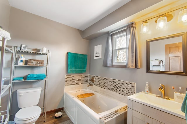 bathroom featuring a bath, toilet, decorative backsplash, vanity, and hardwood / wood-style flooring