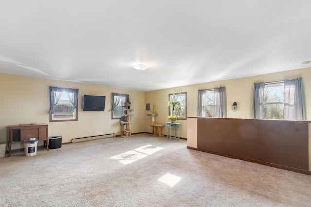 unfurnished living room with light colored carpet and a baseboard heating unit