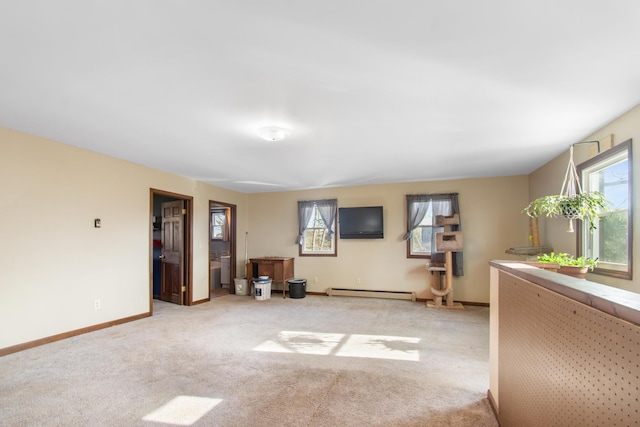 unfurnished living room with light carpet and a baseboard heating unit