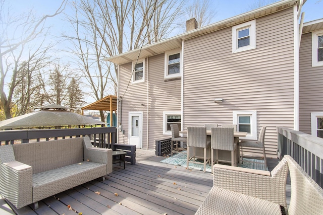 wooden deck featuring a gazebo and outdoor lounge area