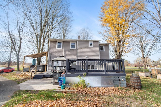 back of property with a patio area and a wooden deck