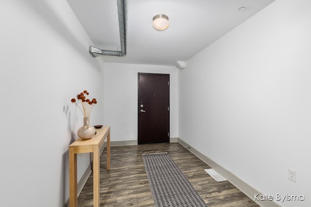 doorway to outside with dark hardwood / wood-style floors