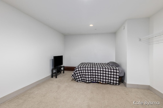 bedroom featuring light carpet