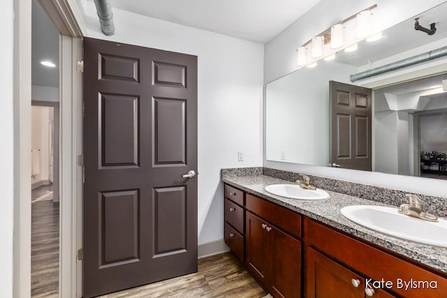 bathroom with hardwood / wood-style flooring and vanity