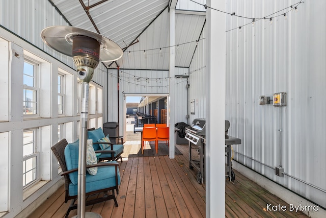 sunroom / solarium featuring lofted ceiling